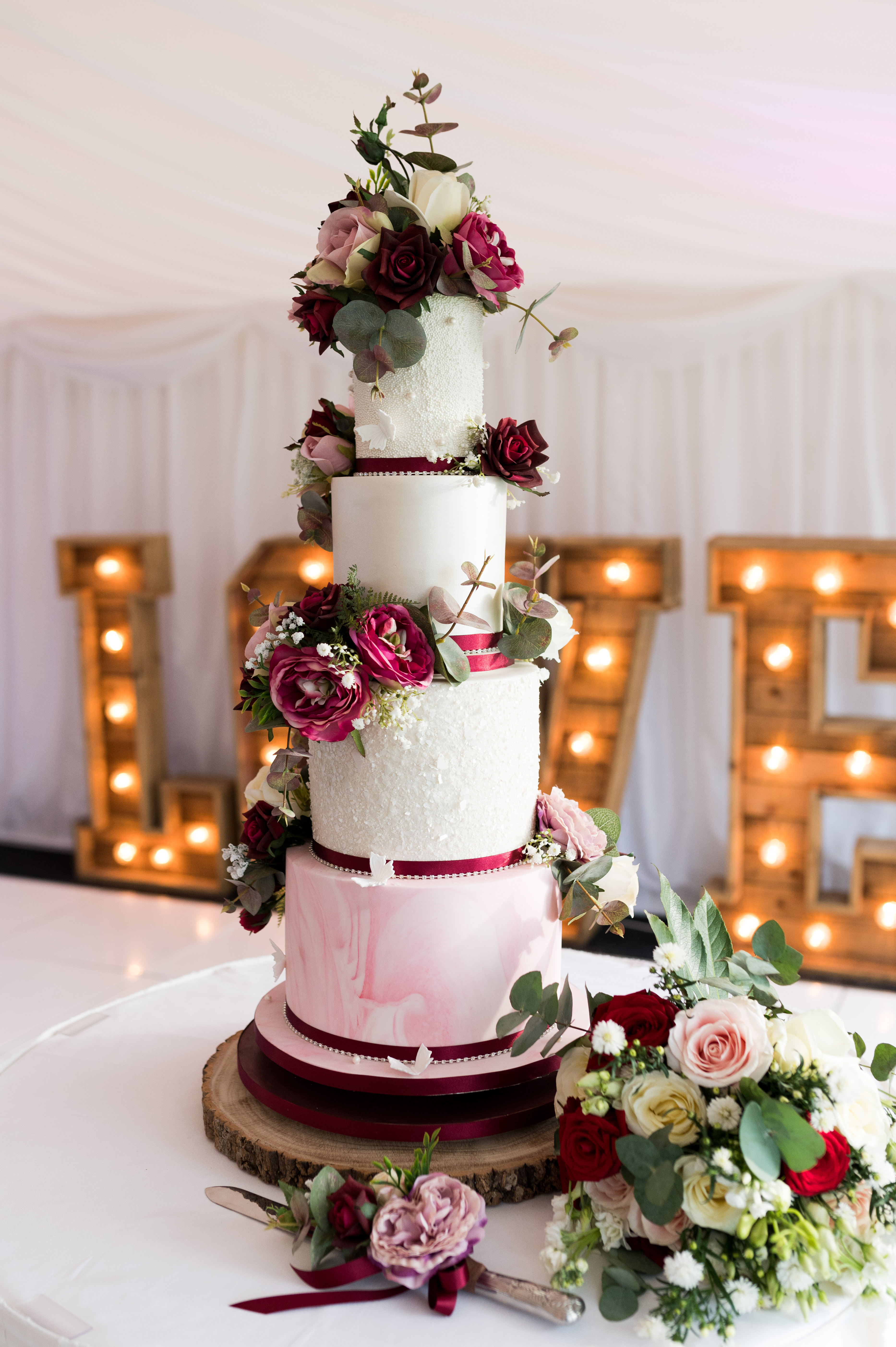 Bespoke floral wedding cake in deep pink and burgundy